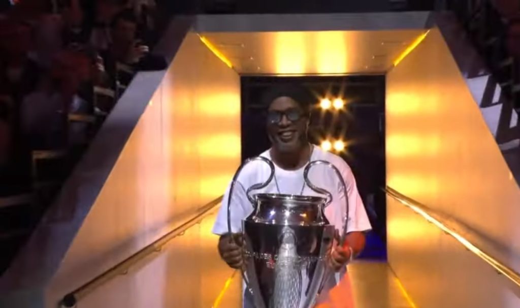 Ronaldinho bringing in the UEFA Champions League trophy