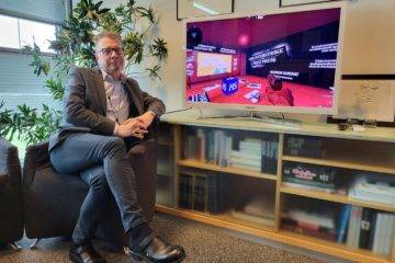 Helsingin Sanomat Editor-In-Chief Antero Mukka sitting close to the television showing the strategy released on the world press freedom day (Photo credit REUTERS Anne Kauranen)