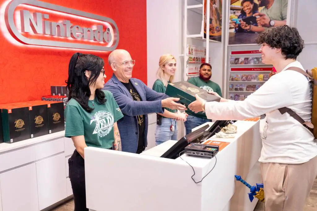 Nintendo of America President Doug Bowser sells the very first copy of The Legend of Zelda Tears of the Kingdom to an excited fan